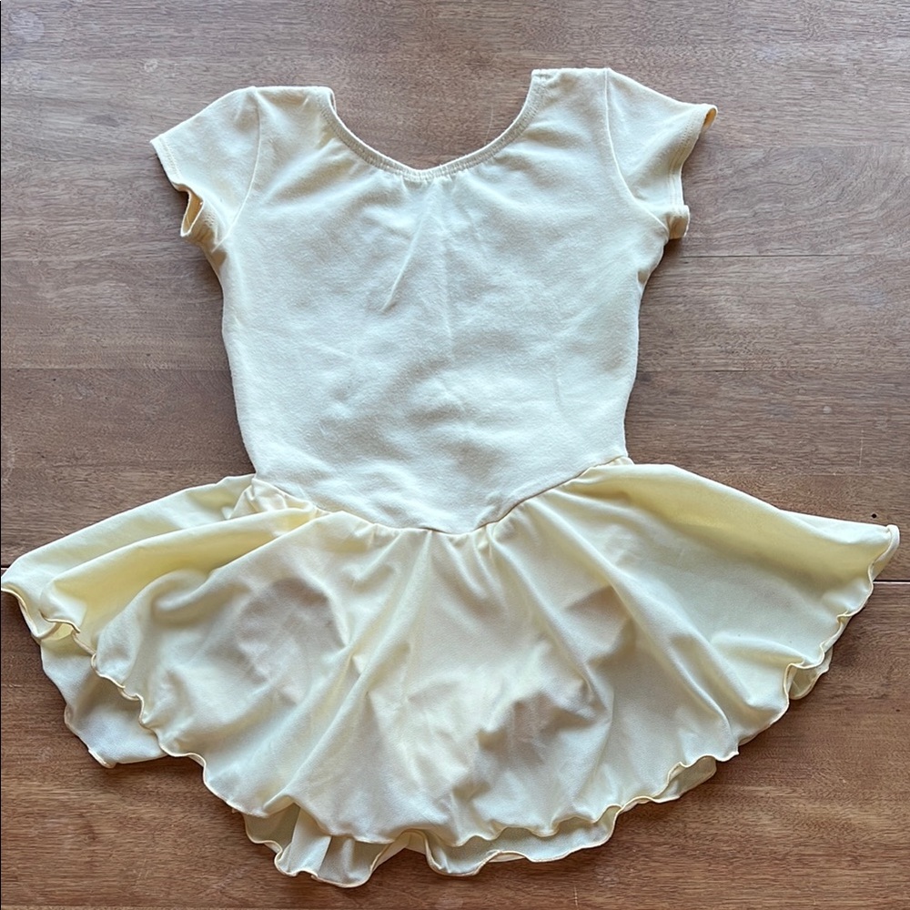 Charming yellow girl’s leotard with attached skirt